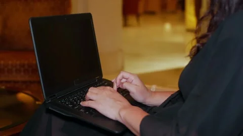 Person typing on laptop in indoor setting with warm lighting Stock-Footage 341423882