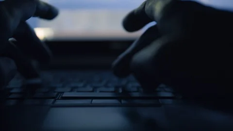 Person Typing on Laptop Keyboard at Night - Concept for Hacking, Programming Stock Footage