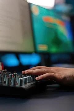 Person typing on midi keyboard with computer screen 스톡 사진