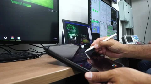 Person typing on a tablet in control room Stock Footage 215683146