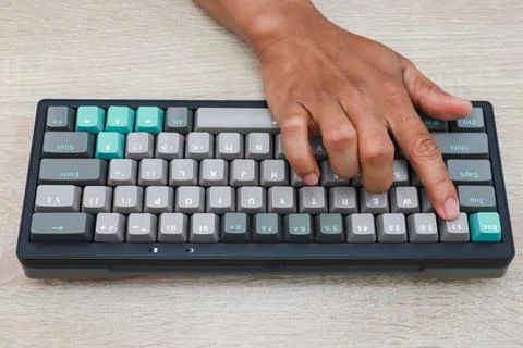 Person Typing on Teal and Gray Mechanical Keyboard Stock Photos