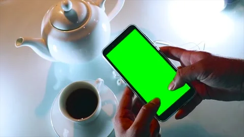 A Person is Typing Using a Mobile Phone With a Green Screen. Stock Footage 170155576
