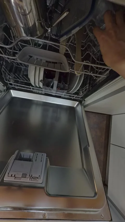 Person unloading clean dishes from a dishwasher pov Stock Footage 340589892