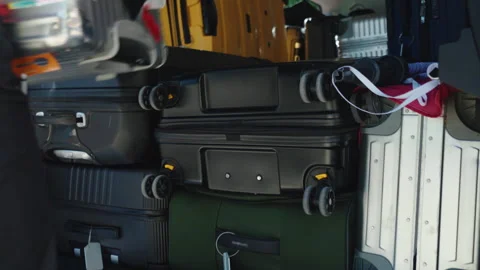 Person unloading suitcases in open van trunk, capacious automobile trunk full of Stock Footage 303749519