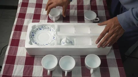 Person Unpacking Ceramic Tea Set Stock Footage 339563820
