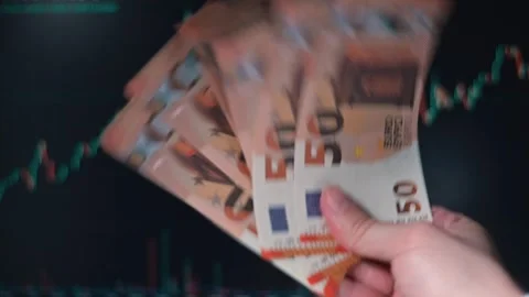 A person of unspecified gender is handling a stack of euro banknotes while Stock Footage 338301426