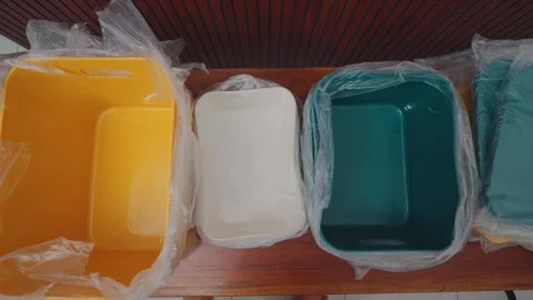 Person Unwrapping Yellow Plastic Storage Bin from Plastic Packaging Stock Footage 333321853