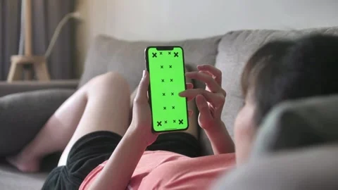 Person use smartphone while relaxing in sofa family room of the house screen on Video stock 336585721