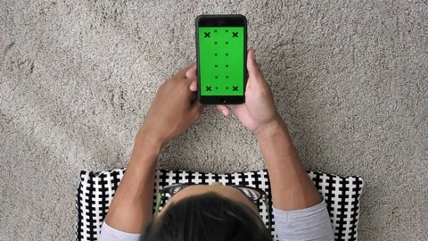 Person use smartphone while relaxing in the room of the house screen on mobile Stock-Footage 336585738