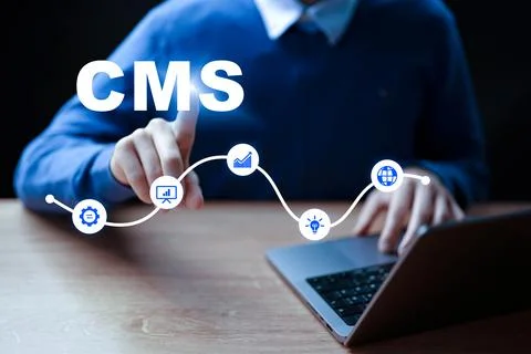 Person uses CMS for website management and content creation at a desk in an Stock Photos