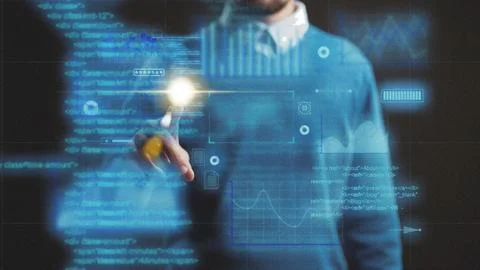 Person uses digital tools to analyze data on a transparent screen in an office Stockfoto's