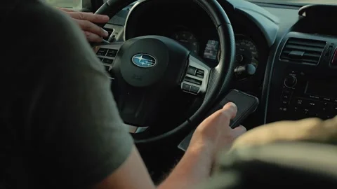 A person uses a mobile device for navigation or texting while driving Stock Footage 346472093
