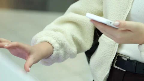 Person uses phone, gestures while standing indoors Stock Footage 345678460