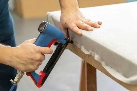 A person uses a pneumatic stapler Fotos Stock