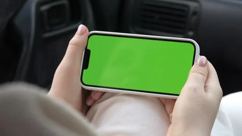 Person uses smartphone with green screen while sitting in vehicle Stock Footage 343853989