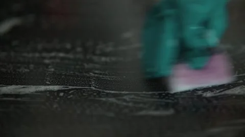 A person uses a sponge with cleaning modern induction electric stove, focusing Stockbeeldmateriaal 337112055