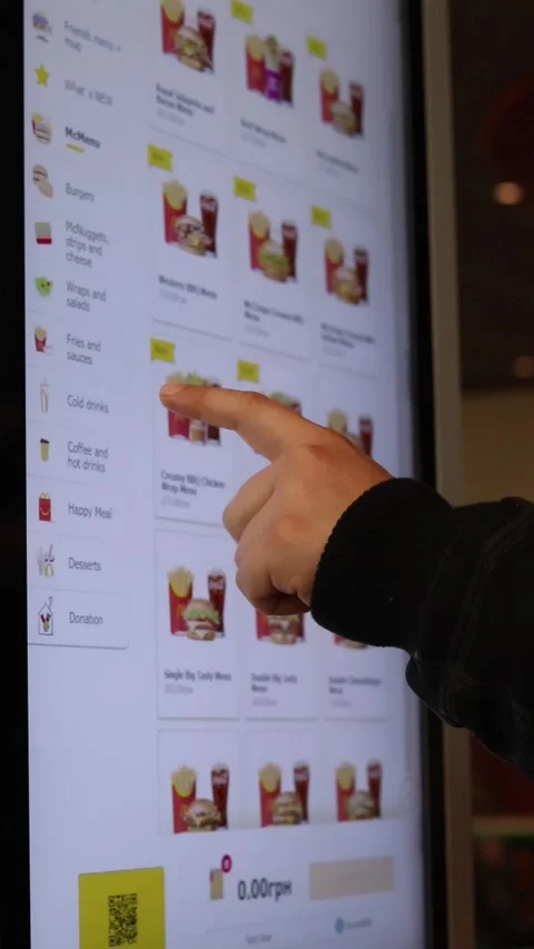 A person uses the touchscreen of a McDonald's self-service kiosk in Ukraine. Stock Footage 332597830