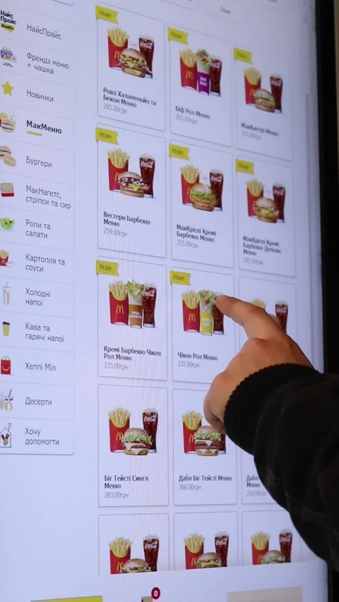 A person uses the touchscreen of a McDonald's self-service kiosk in Ukraine. Stock Footage 332597880