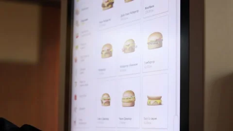 A person uses the touchscreen of a McDonald's self-service kiosk in Ukraine. Stock Footage 332597895