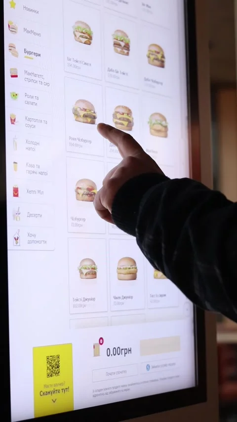 A person uses the touchscreen of a McDonald's self-service kiosk in Ukraine. Stock Footage 332597899