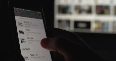 Person uses Uber App to get a car to him up. Stock Footage 149437882
