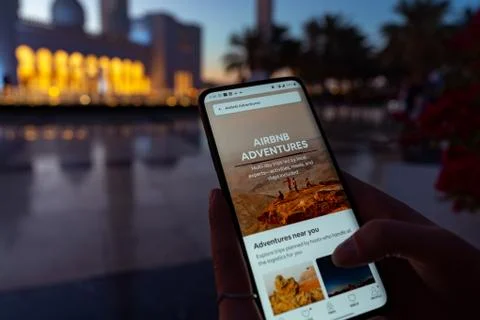 A person using the Airbnb app | exploring travel destinations | adventures Stock Photos