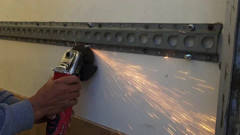 A person using a angle grinder to cut a metal bolt. Stock Footage 239550592