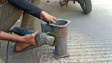 Person Using an Angle Grinder for Metalwork Outdoors Stock Footage 297281407