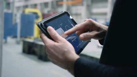 Person using an app on his tablet in a company Stock Footage