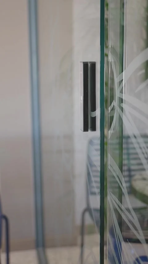 Person Using Biometric Fingerprint Scanner to Unlock Glass Office Door Stock Footage 345384557