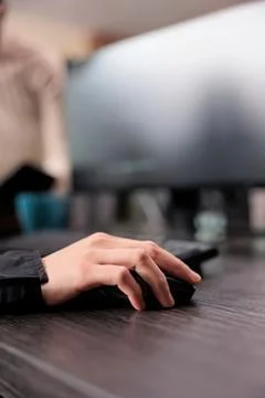Person using a black computer mouse on desk Stock Photos