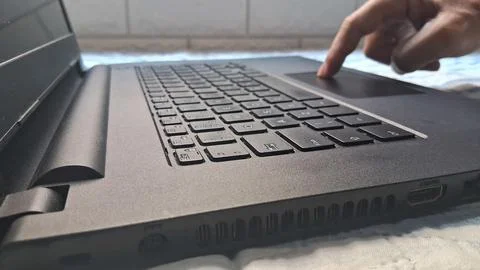 Person using a black laptop computer with a touch pad interface Stock Photos