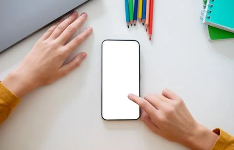 Person Using Blank Smartphone Flat Lay Next to Laptop 写真素材