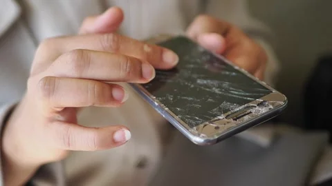 Person using a broken smartphone screen in public space Stock Footage 337285412