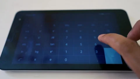 Person using a calculator app on a tablet, performing calculations Stock Footage 317736808