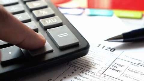 Person using calculator over tax forms with pen on office desk background s.. Stock Footage 333030973