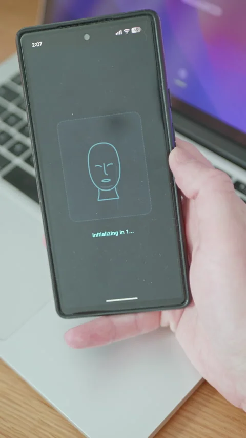 Person using cell phone with digital facial recognition scanner interface Stock Footage 335527872