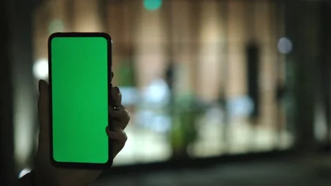Person using cell phone with green screen for communication and mobile tasks Stock Footage 276339217