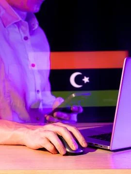 Person using computer with holographic flag featuring crescent and star pro.. Stock Photos