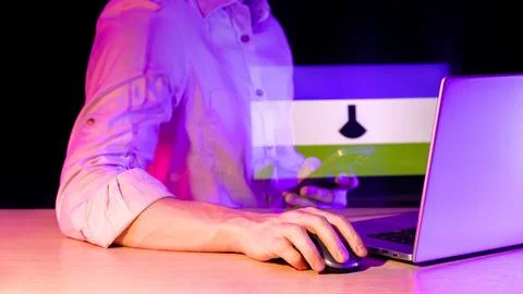 Person using computer with holographic lab flask icon overlay Stock Photos