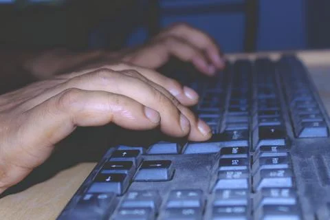 A person using a computer keyboard. Stock Photos