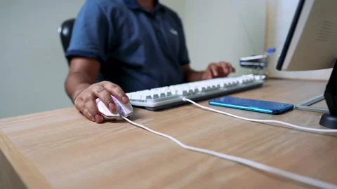 Person Using Computer Mouse and Keyboard at Desk Stock Footage 315981375