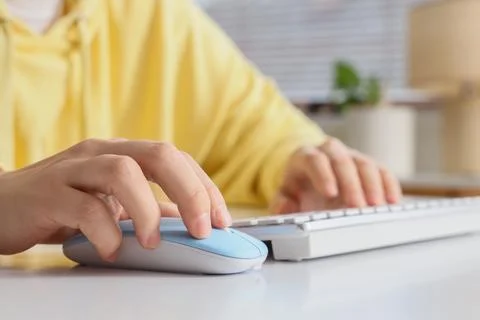 Person using computer mouse and keyboard Stock Photos