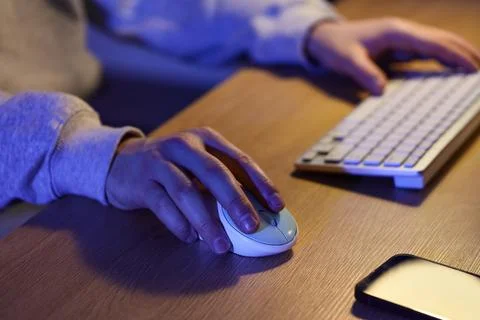 Person using computer mouse and keyboard at desk Stock Photos