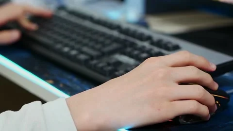A person using a computer mouse, a person playing a game on a desktop compute Stock Footage 166322487