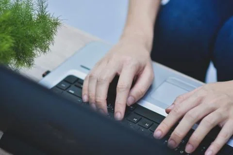 Person using computer notebook working at home Stock Photos