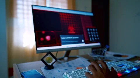 Person using a computer with a red-themed interface, keyboard, and document.. Video stock 315982021