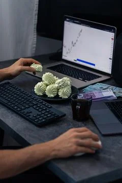 Person using computer with stock market chart on screen, keyboard and mouse.. Photos
