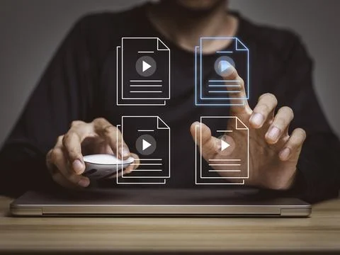 Person using computer for watching video on the internet watch movies, list.. Stock Photos