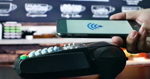 Person using contact less payment with smartphone payment terminal Point of Sale Stock Footage 336585630